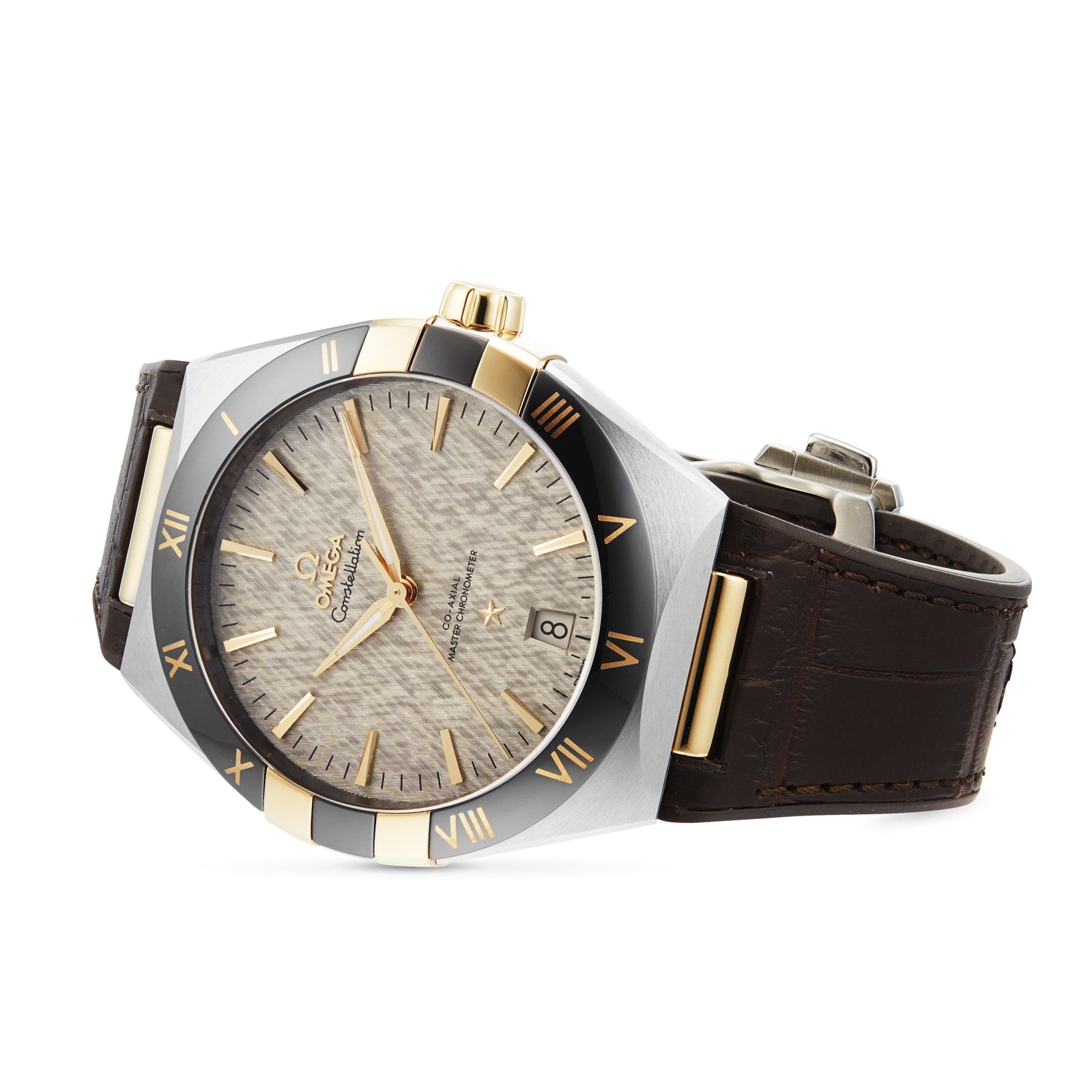 The OMEGA Constellation watch features a textured beige dial with gold Roman numerals, a two-tone bezel, and a brown leather strap, tilted to display its master chronometer-certified precision and timeless elegance.