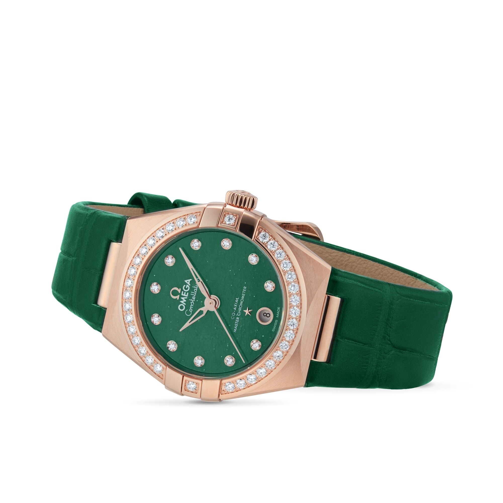 The OMEGA Constellation, a gold and diamond watch with diamond hour markers, green strap and dial, and Master Chronometer certification, is shown against a white background.