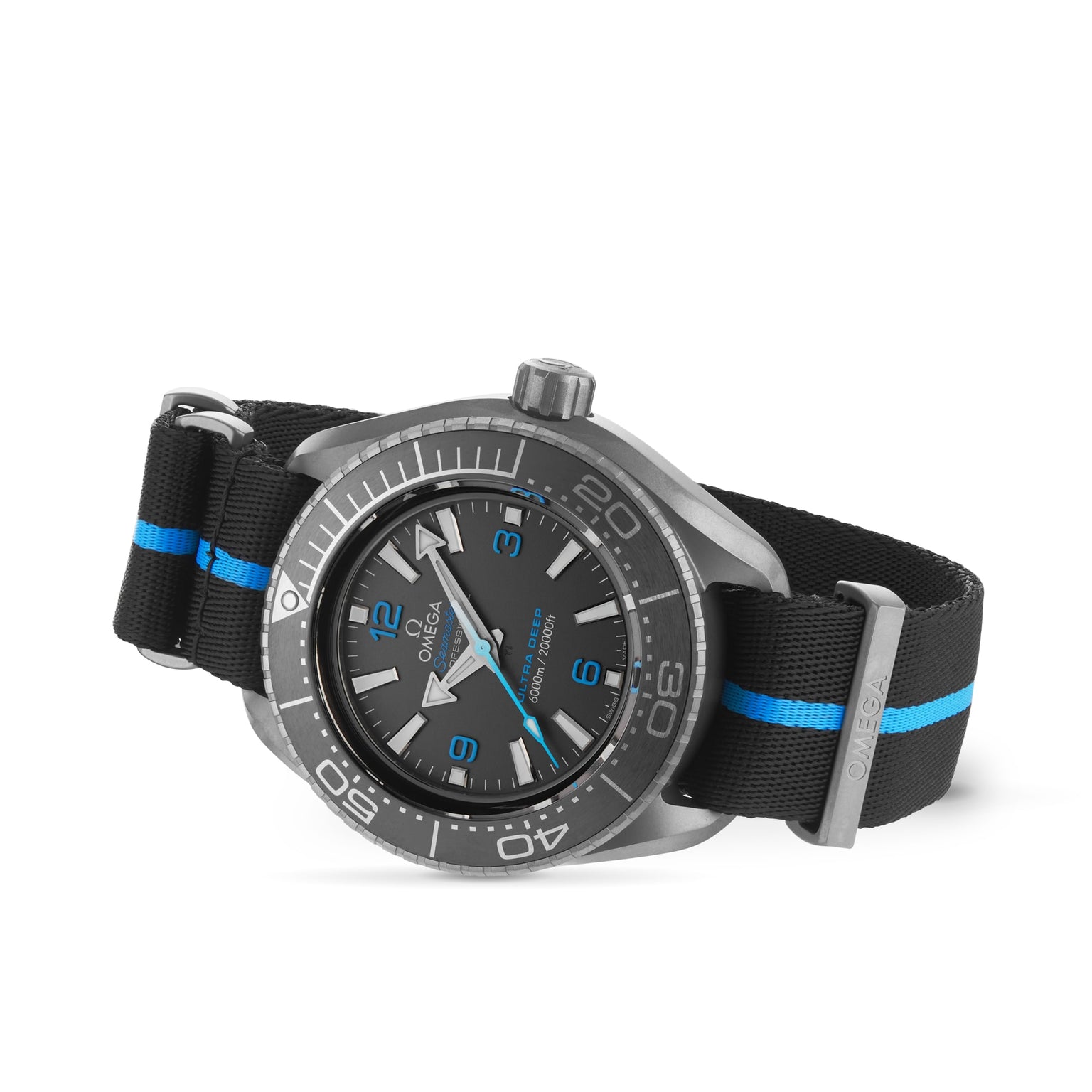 The OMEGA Seamaster Planet Ocean 6000M, featuring a black dial, gray bezel, blue accents, and a black nylon strap with blue stripes, is stylishly angled on a white background.