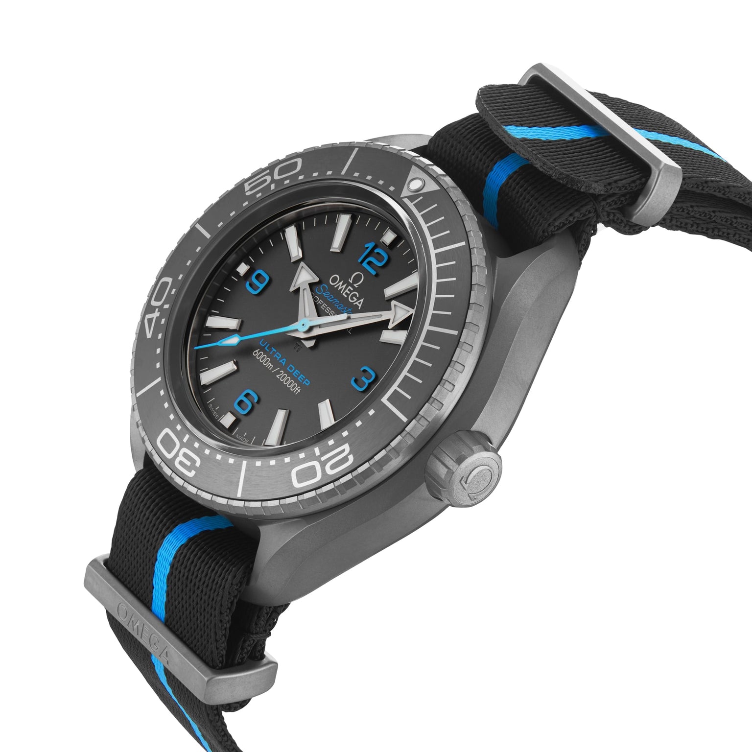 An OMEGA Seamaster Planet Ocean 6000M dive watch, grey with a black dial, blue and white accents, and a black textile strap with blue striping, shown at an angle.
