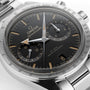 Close-up of an OMEGA Speedmaster 57 with a black dial, stainless steel case and bracelet, three subdials, tachymeter bezel, Co-Axial Master Chronometer movement; time shown is 10:10:34 and date is the 8th.
