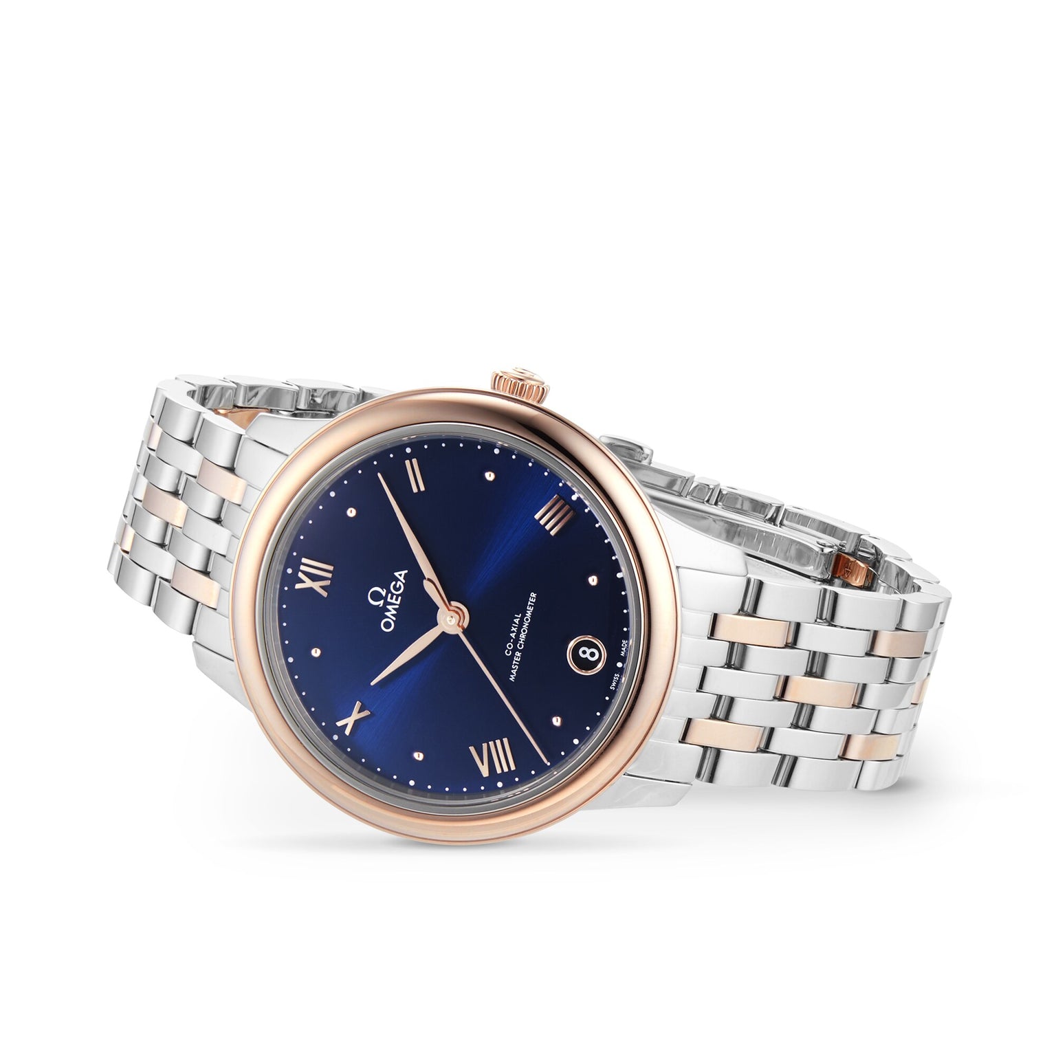 The OMEGA De Ville Prestige features a two-tone metal bracelet, gold bezel, PVD blue dial with Roman numerals, date at 3 o’clock, and is powered by the Omega Master Co-Axial 8800 movement.