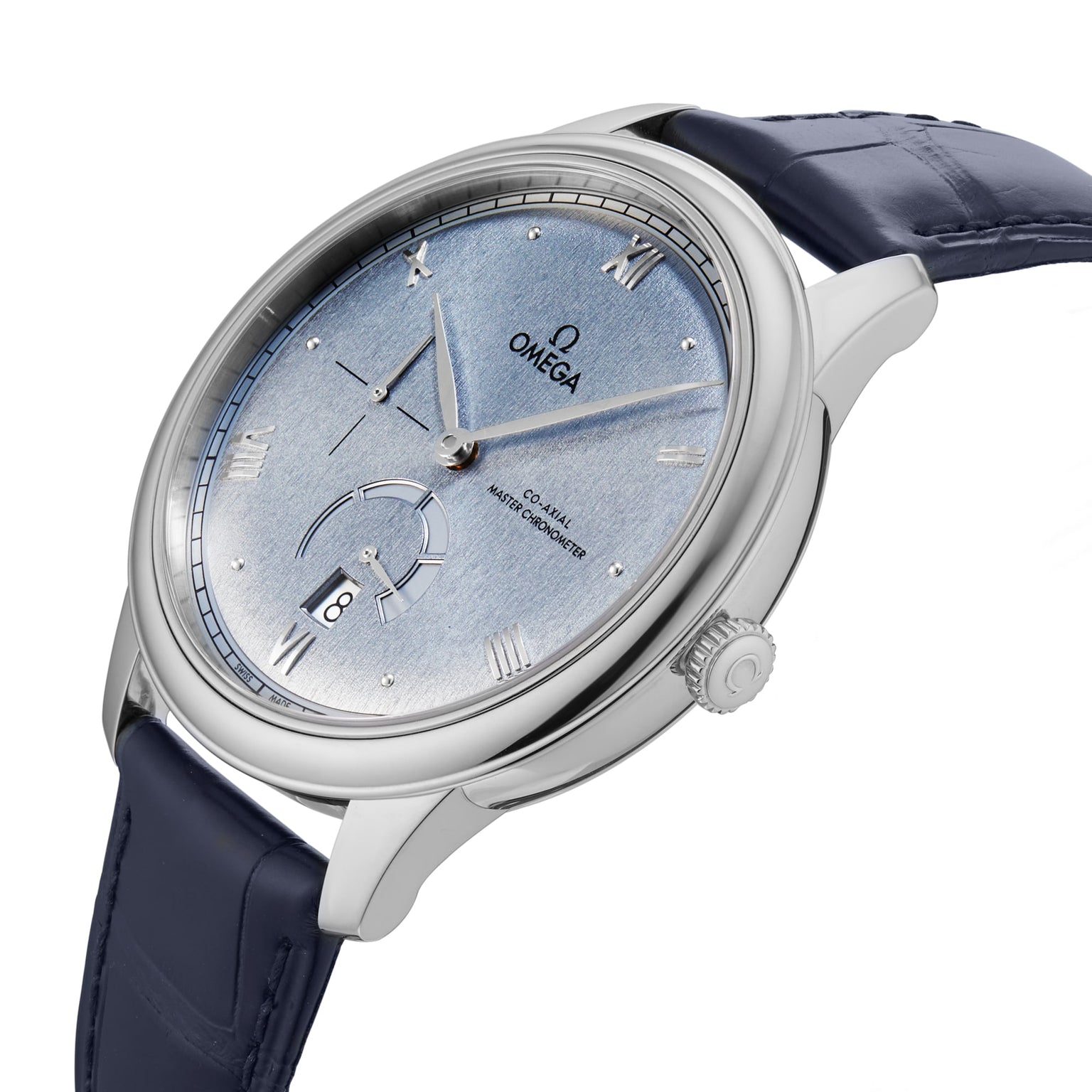 A close-up of the OMEGA De Ville Prestige wristwatch, featuring a stainless steel case, blue leather strap, light blue dial with Roman numerals, and a date display at 6 o’clock.