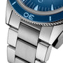 Close-up of the OMEGA Seamaster 300 Summer Blues stainless steel bracelet and case, featuring a blue bezel and detailed links, with part of the watch face and numerals, crafted to Master Chronometer standards.