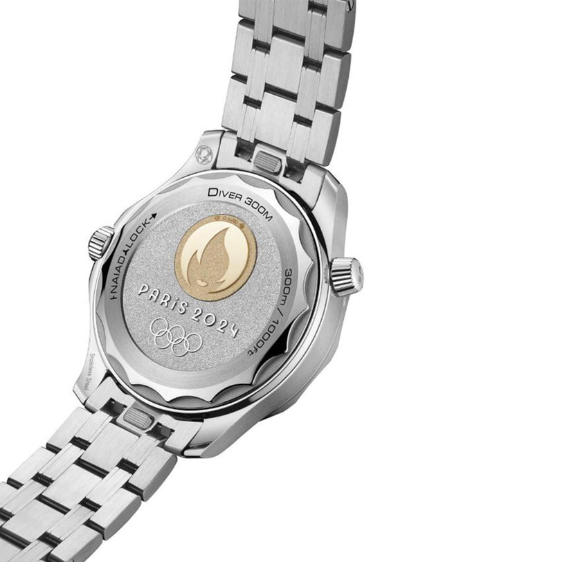 Close-up of the OMEGA Seamaster Diver 300M Paris 2024’s caseback, engraved with the Paris 2024 Olympic Games emblem, flame symbol, Official Timekeeper wording, and water resistance details.