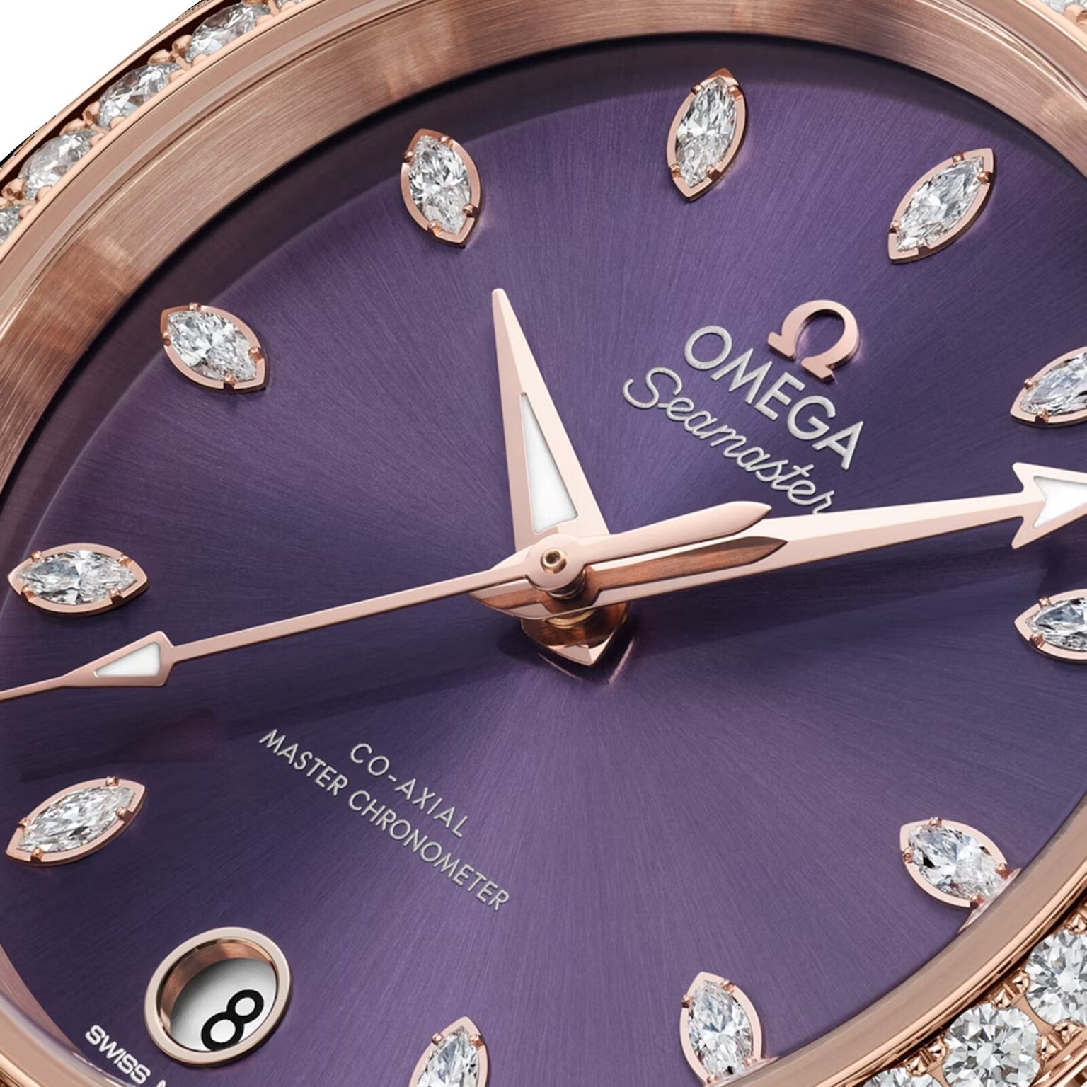 Close-up of the OMEGA Seamaster Aqua Terra Shades watch, showcasing a lavender dial, diamond hour markers, 18K Sedna™ Gold hands, and a date window at 6 o’clock.