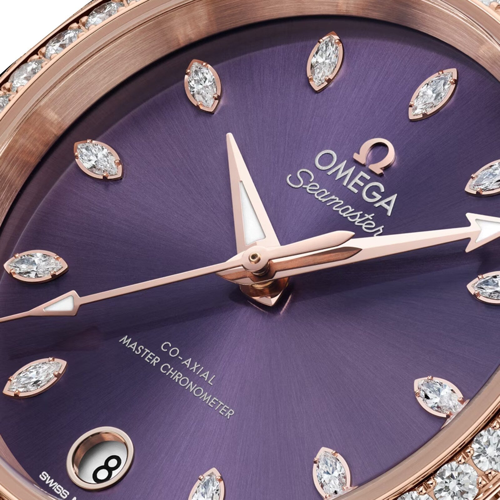 Close-up of the OMEGA Seamaster Aqua Terra Shades watch, showcasing a lavender dial, diamond hour markers, 18K Sedna™ Gold hands, and a date window at 6 o’clock.
