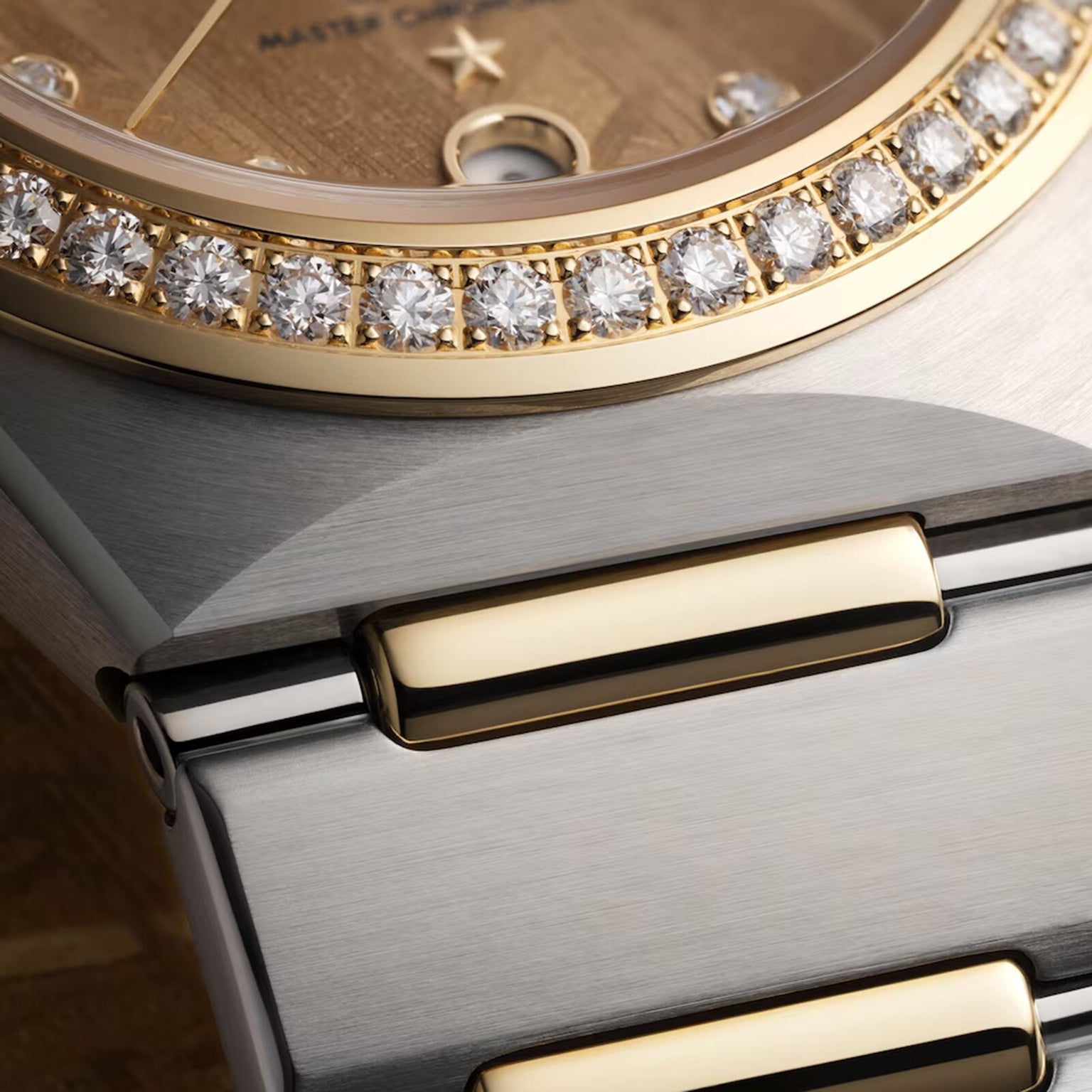 Close-up of the OMEGA Constellation, showcasing its gold diamond-set bezel and brushed metal bracelet.