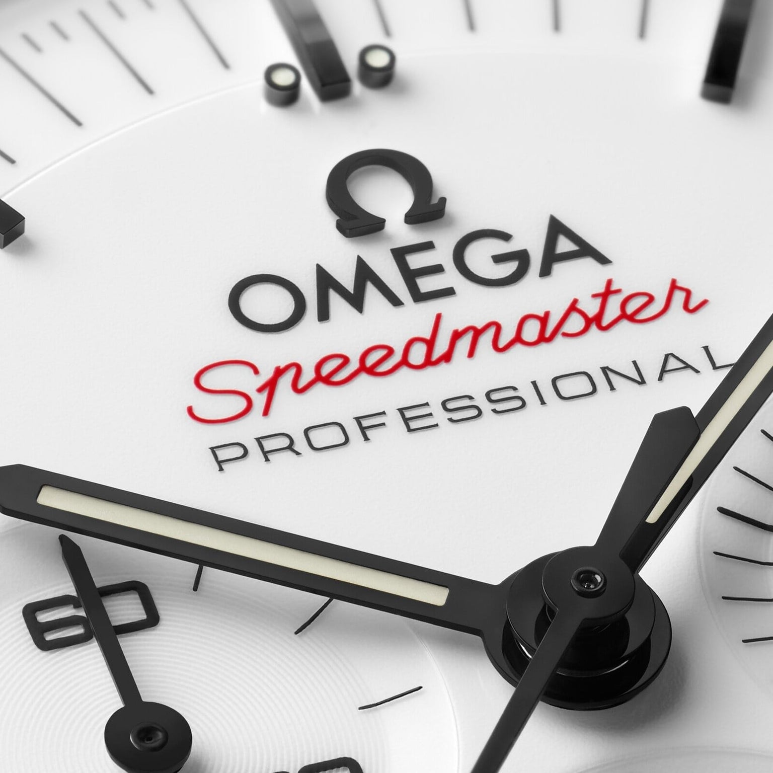 Close-up of a white OMEGA Speedmaster Moonwatch Professional dial, featuring black hands, indices, red Speedmaster text, and the iconic chronograph design.