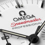 Close-up of the OMEGA Speedmaster Moonwatch Professional face, featuring the brand name and model in black and red text, with distinctive black and white hands.