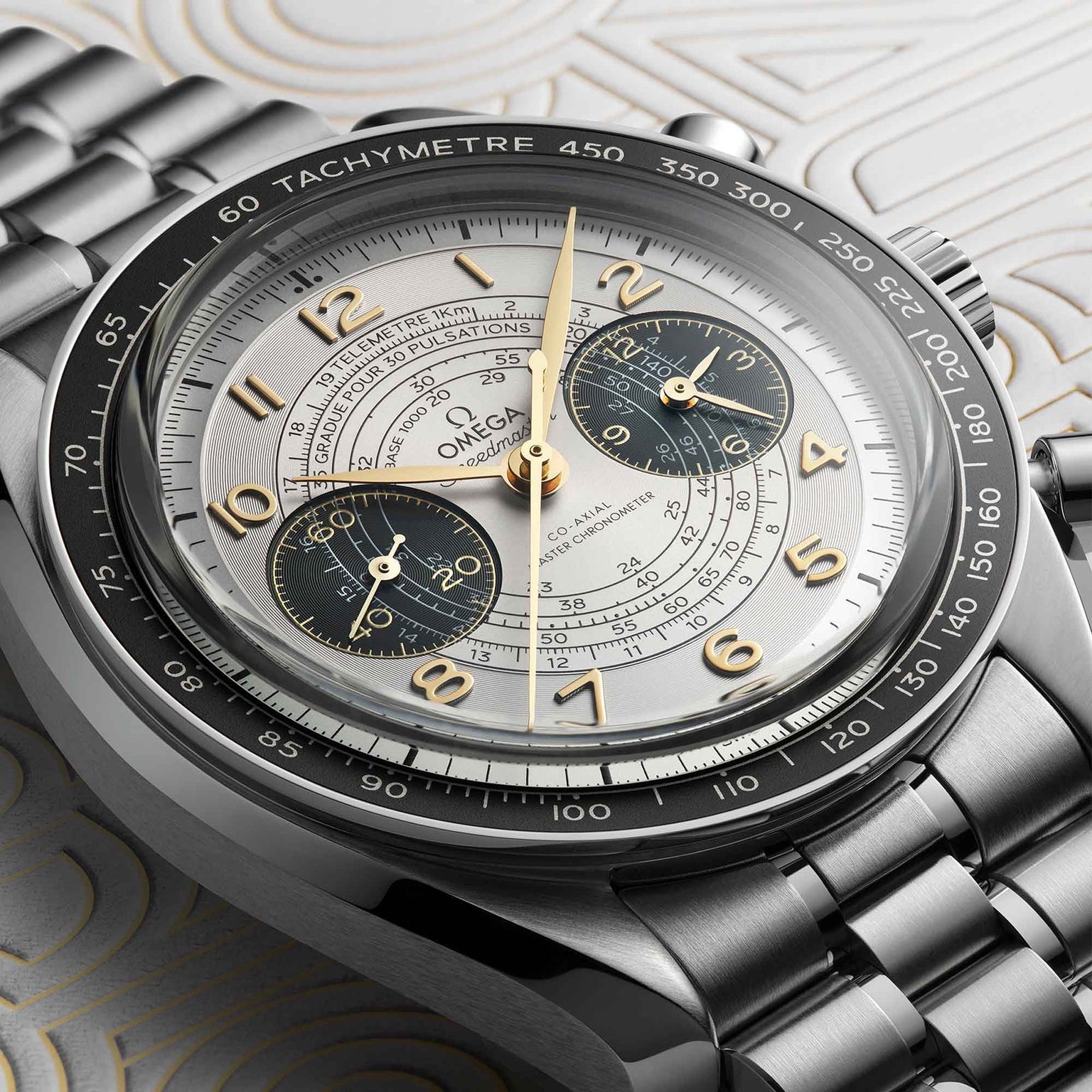Close-up of the OMEGA Speedmaster Chronoscope Paris 2024 Olympics, featuring a stainless steel band, black tachymeter bezel, and three subdials on a silver patterned dial.