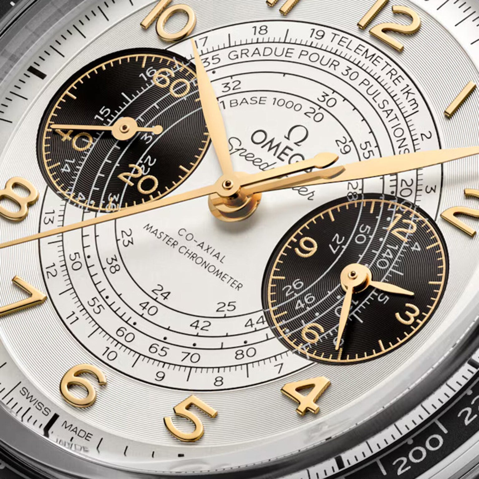 Close-up of the OMEGA Speedmaster Chronoscope Paris 2024 Olympics, featuring gold hour markers, subdials, and bilingual measurement scales, crafted to Master Chronometer standards for the Paris 2024 Games.