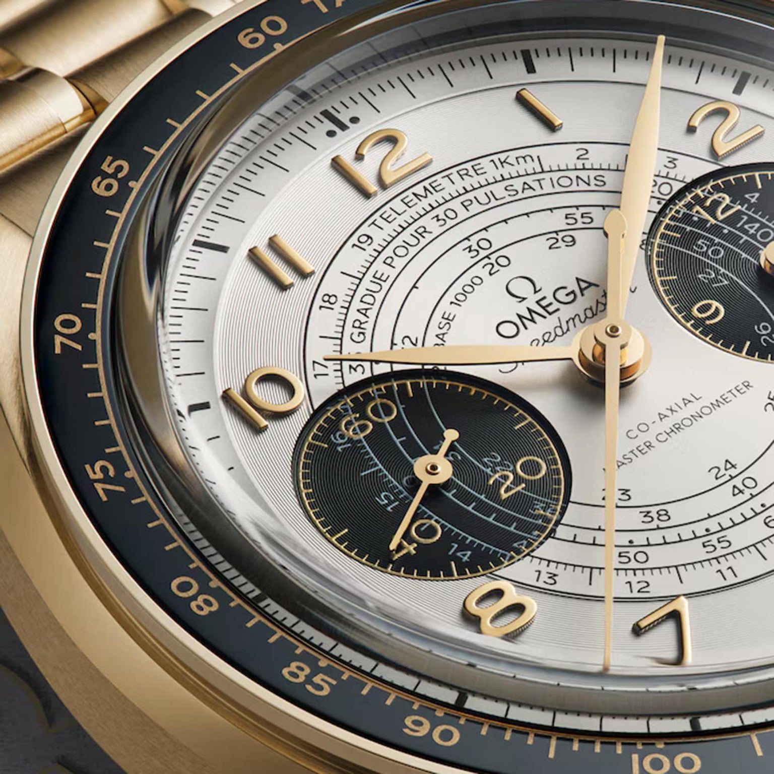 Close-up of the OMEGA Speedmaster Chronoscope Paris 2024 Olympics, featuring gold hands, three subdials, and tachymeter, telemeter, and pulsometer scales—Master Chronometer from the Speedmaster collection.