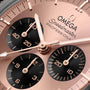 Close-up of the OMEGA Speedmaster Moonwatch Professional Sedna, showcasing rose gold hands in Sedna™ Gold and three black sub-dials for seconds, minutes, and hours.