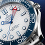 Close-up of the OMEGA Seamaster Diver Americas Cup 300M, featuring a white textured dial, blue bezel, blue markers, red-tipped second hand, and 300m/1000ft water resistance—an icon tied to the Americas Cup.