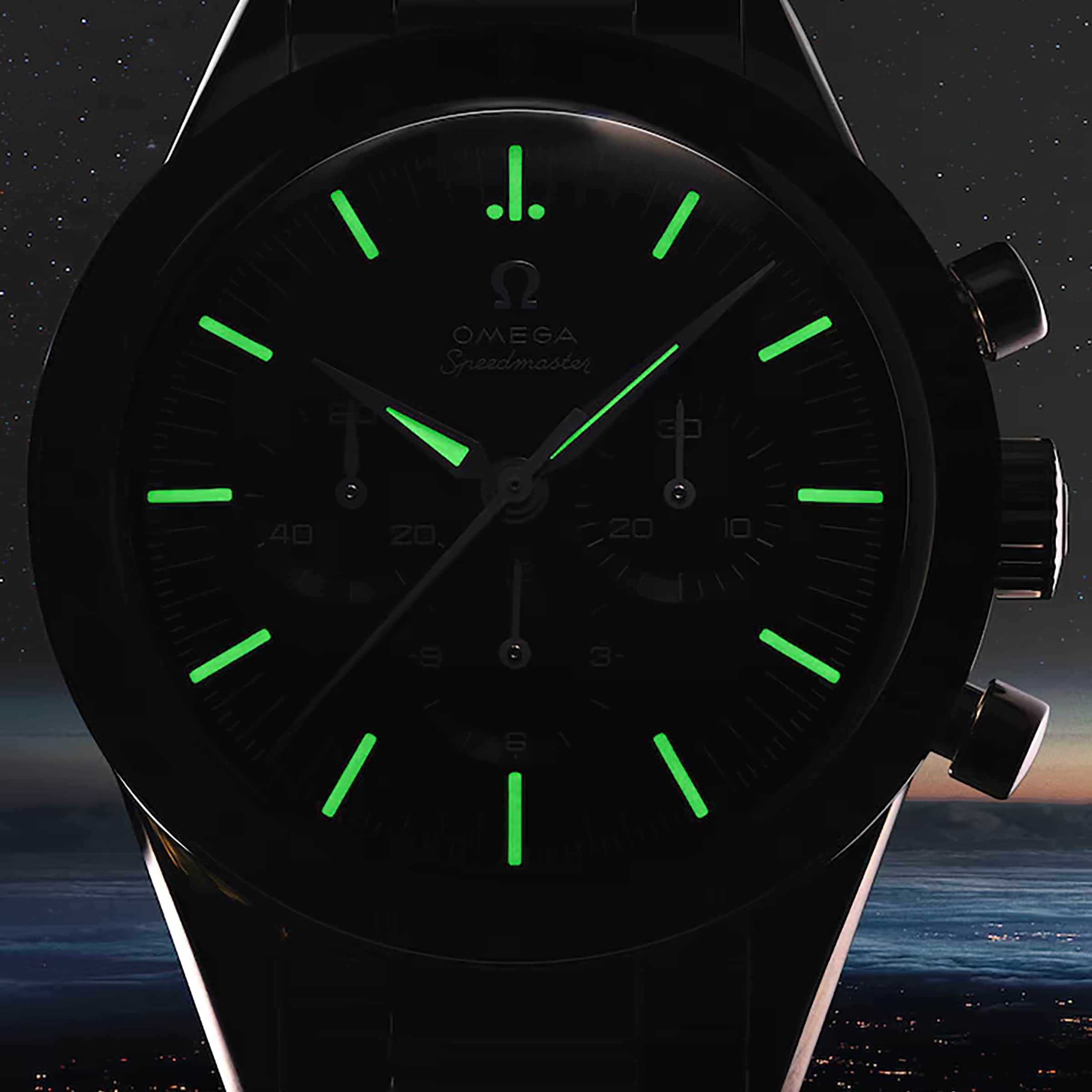 A close-up of the OMEGA Speedmaster First OMEGA in Space watch in the dark, with glowing green hour markers and hands against a starry night sky, and the iconic tachymeter scale subtly visible.