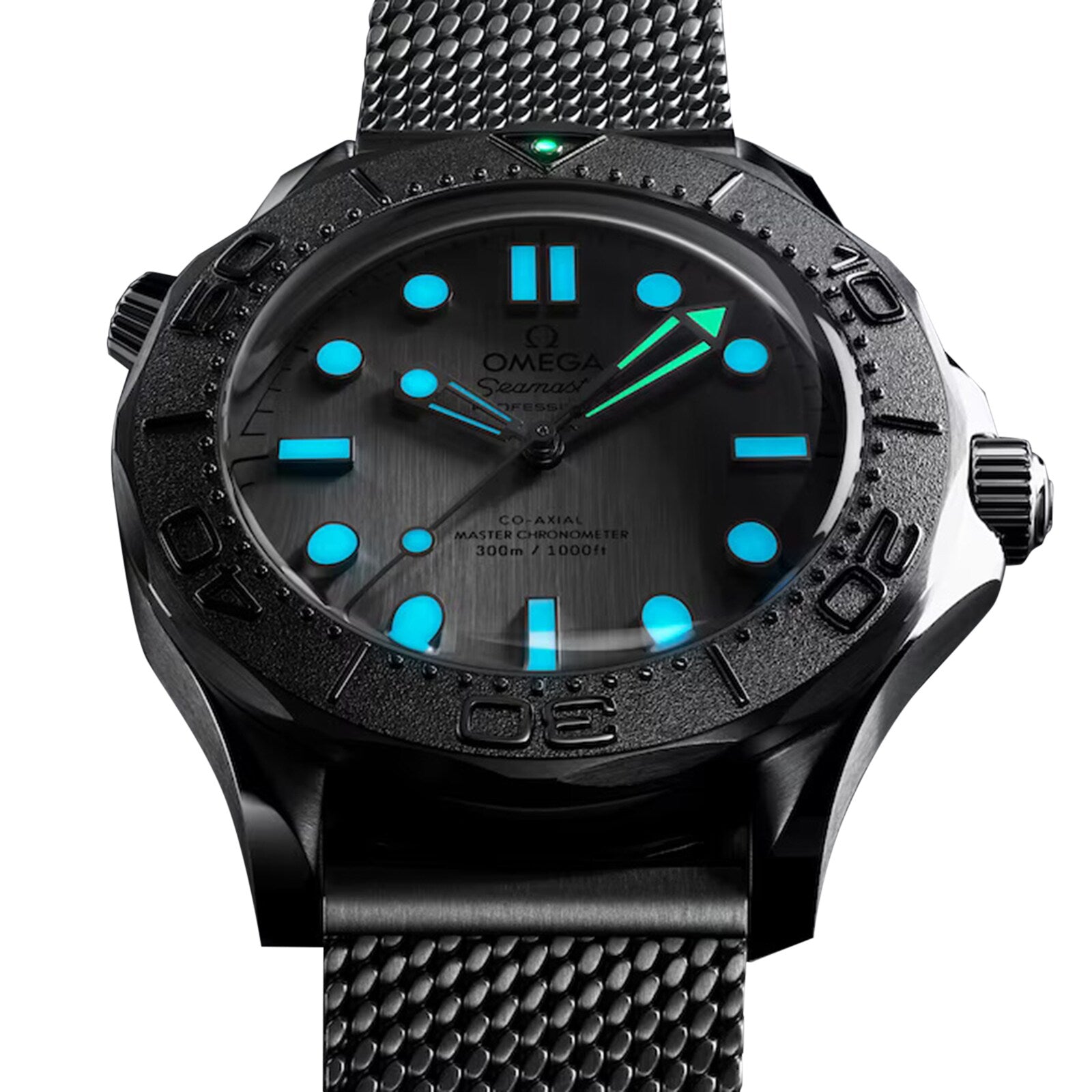 A close-up of the OMEGA Seamaster Diver 300M features a black metal mesh strap, black bezel, glowing blue and green luminous markers and hands, plus a stainless steel case with OMEGA’s Co-Axial Master Chronometer movement.