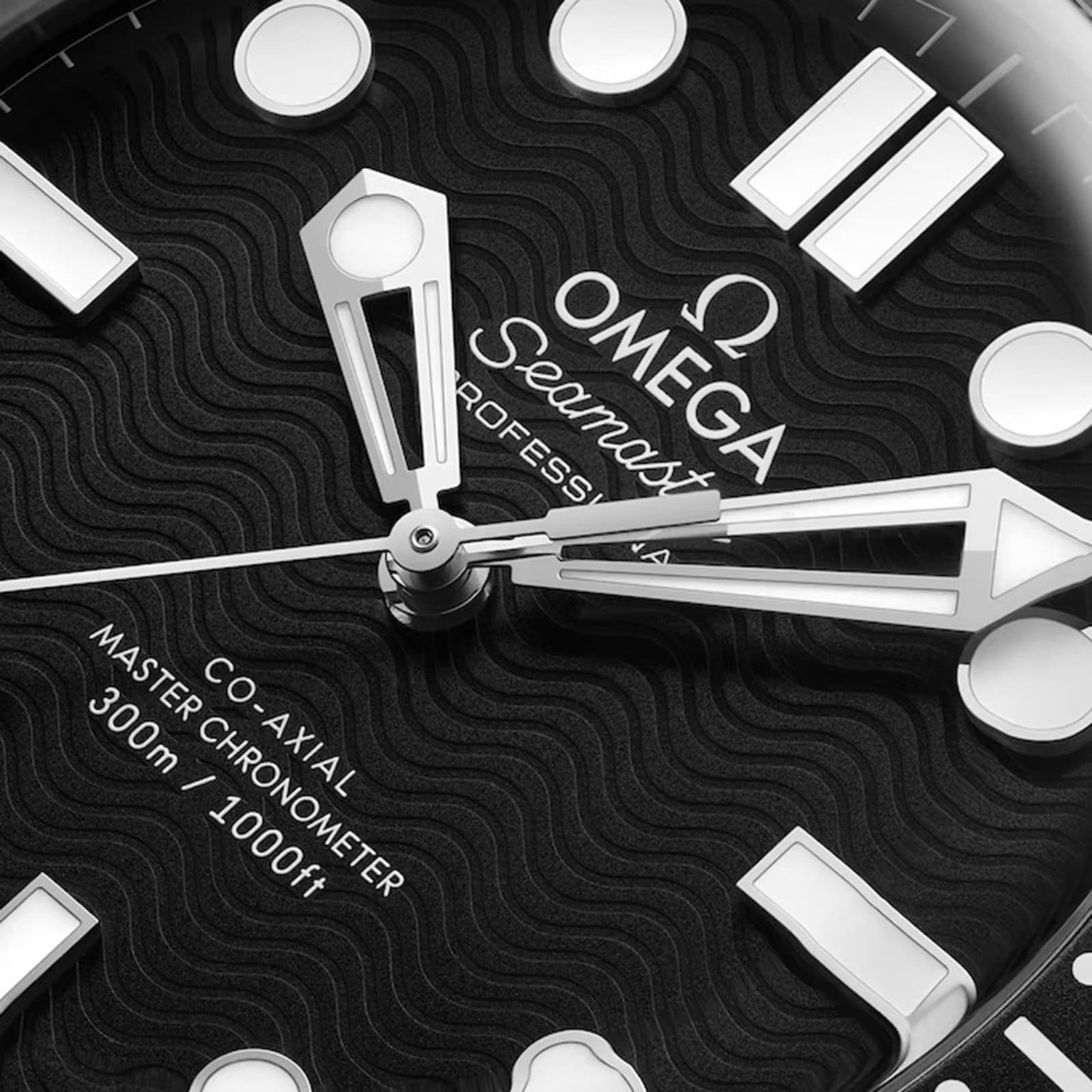 Close-up of the OMEGA Seamaster Diver 300M watch face, highlighting the wavy black dial, stainless steel hands, 300m/1000ft water resistance text, and Co-Axial Master Chronometer designation.