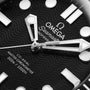 Close-up of the OMEGA Seamaster Diver 300M watch face, highlighting the wavy black dial, stainless steel hands, 300m/1000ft water resistance text, and Co-Axial Master Chronometer designation.