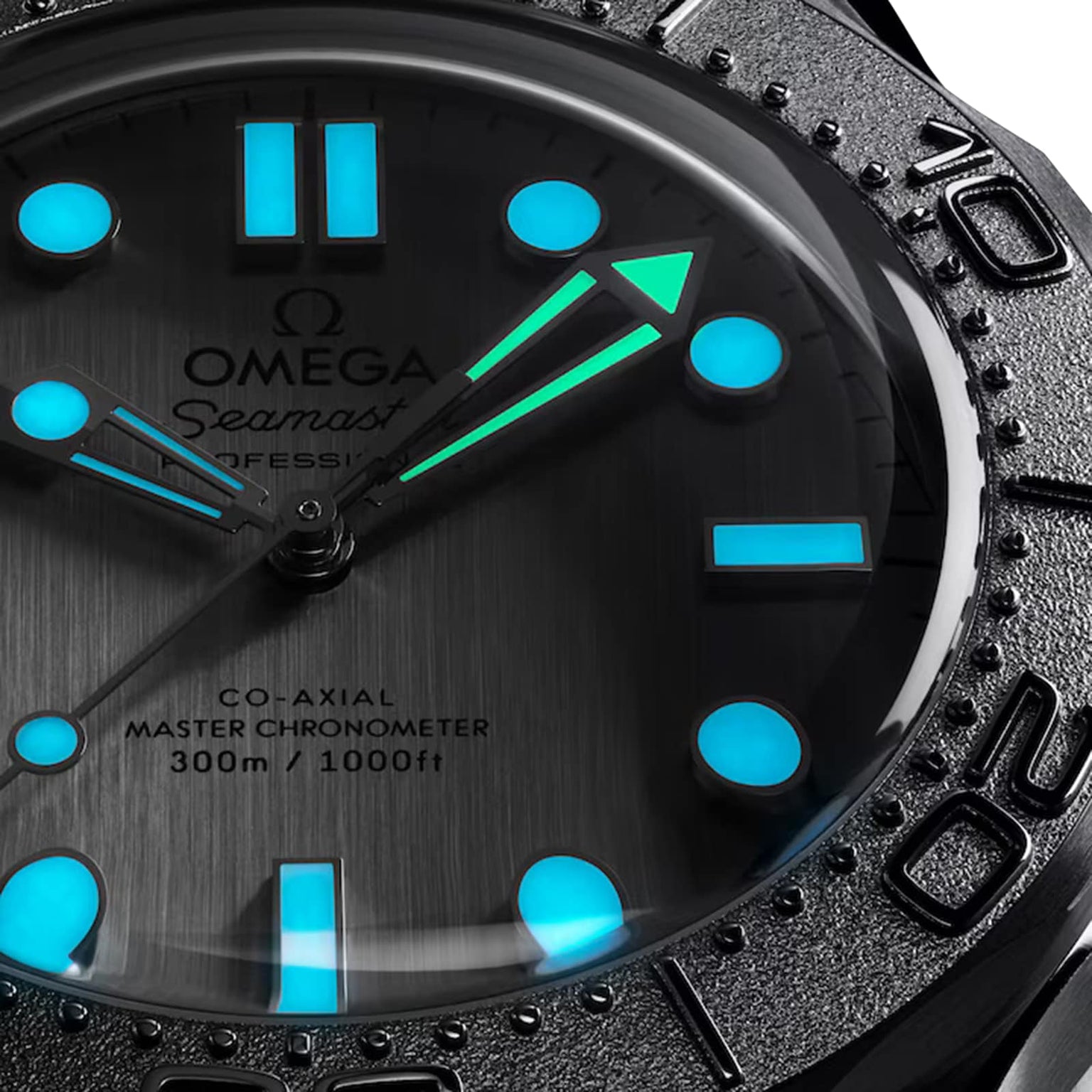 Close-up of the OMEGA Seamaster Diver 300M in stainless steel, showing blue and green luminous markers and hands at 10:08, a black bezel with numerals, and a dial marked 300m / 1000ft and Co-Axial Master Chronometer.