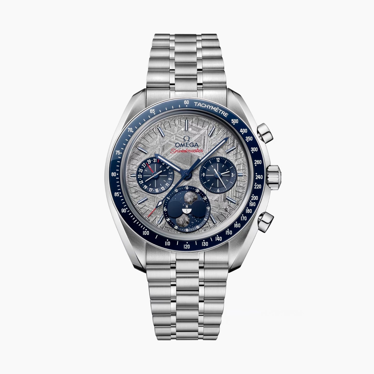 An OMEGA Speedmaster Moonphase Meteorite watch in stainless steel features a blue tachymeter bezel, silver textured dial with chronograph subdials, and a metal bracelet, displayed against a white background.
