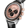 A close-up of an OMEGA Speedmaster Moonwatch featuring a rose gold dial, black subdials, tachymeter bezel, and a black leather strap.