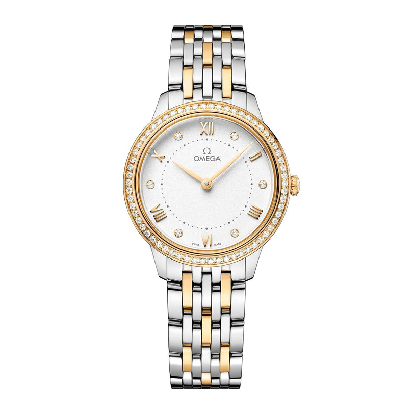 The OMEGA De Ville Prestige features a two-tone silver and gold metal band, white dial, gold Roman numerals, diamond hour markers, and a diamond-set bezel.