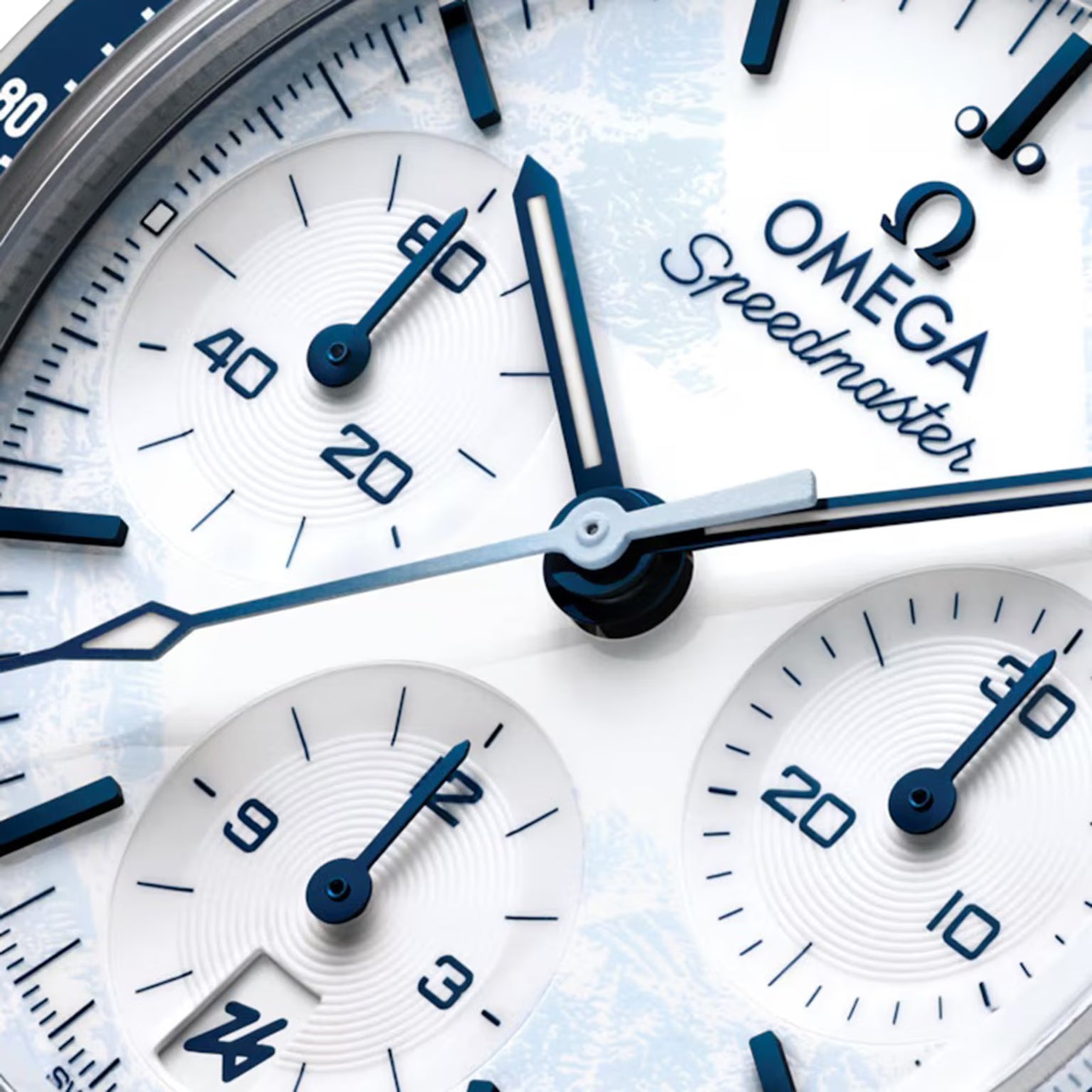 Close-up of an Omega Speedmaster watch face with blue and silver details.