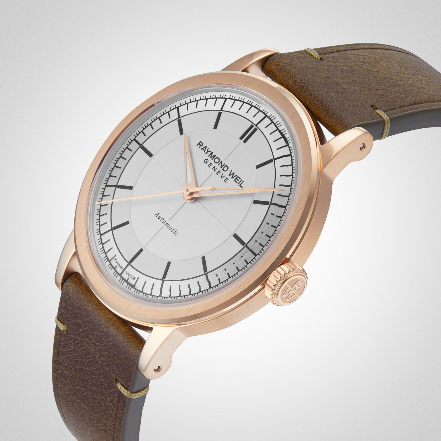 A Raymond Weil Millesime Automatic wristwatch with a silver sector dial and brown leather strap, displayed at an angle.