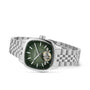 The Raymond Weil Freelancer Calibre RW1212 Automatic features a cushion-shaped stainless steel case, green square dial, silver hour markers, and an exposed RW1212 movement, all displayed at a slight angle.
