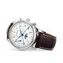 The Longines Master Collection Chrono Moonphase, a silver chronograph with a white dial, blue hands, brown leather strap, and stainless steel case, is shown at an angle against a white background.