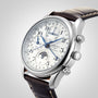 The Longines Master Collection Chrono Moonphase wristwatch features a white dial, blue hands, moonphase chronograph, multiple subdials, date and day displays, leather strap, and polished stainless steel case shown at an angle on a light background.