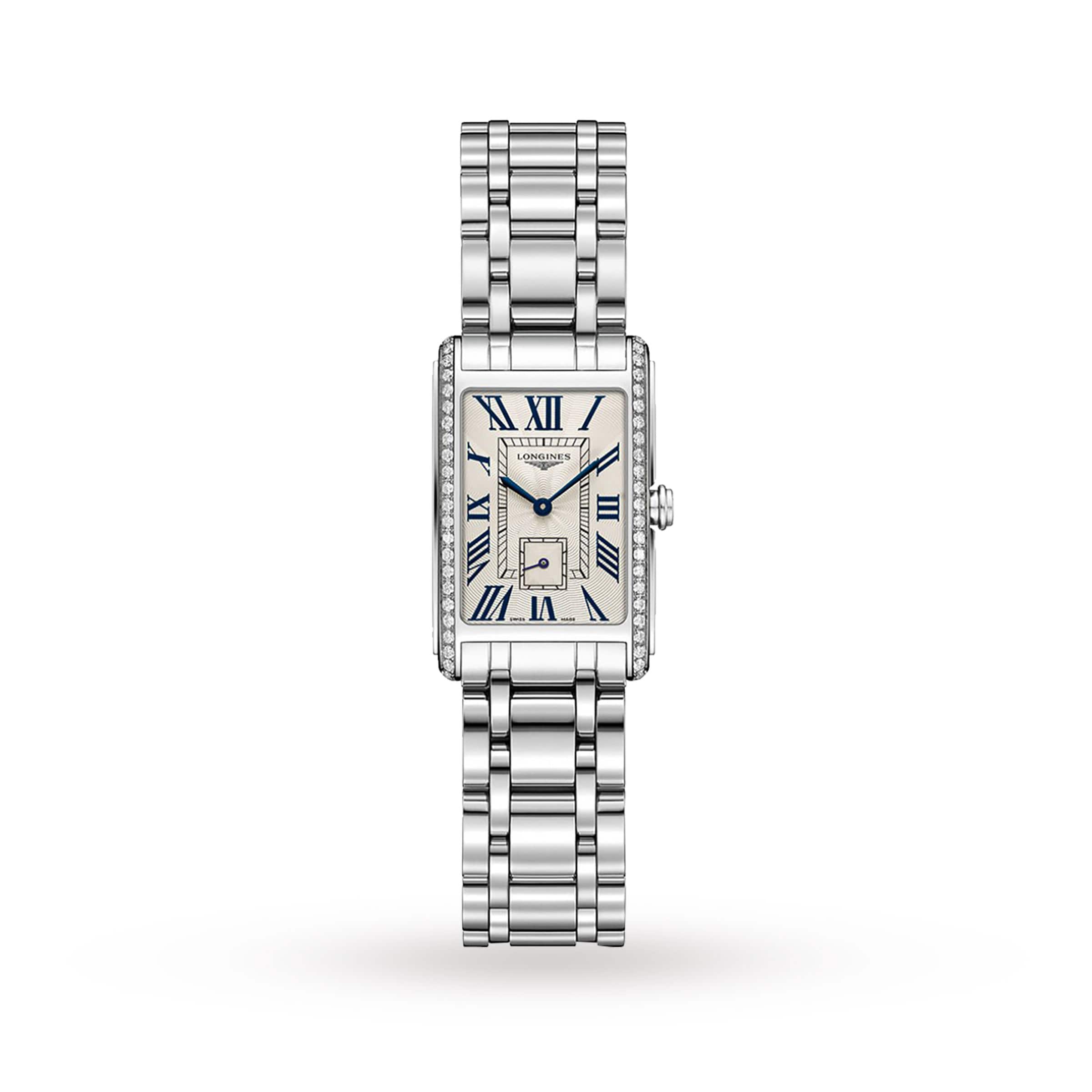 The Longines DolceVita is a rectangular silver women’s watch with a metal link band, Roman numeral markers, blue hands, diamond-accented sides, and a small seconds subdial—embodying Italian-inspired elegance.