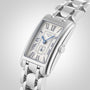 The Longines DolceVita wristwatch features a rectangular silver case, white dial with blue Roman numerals, and a metal link bracelet, combining elegant design with precise quartz movement.