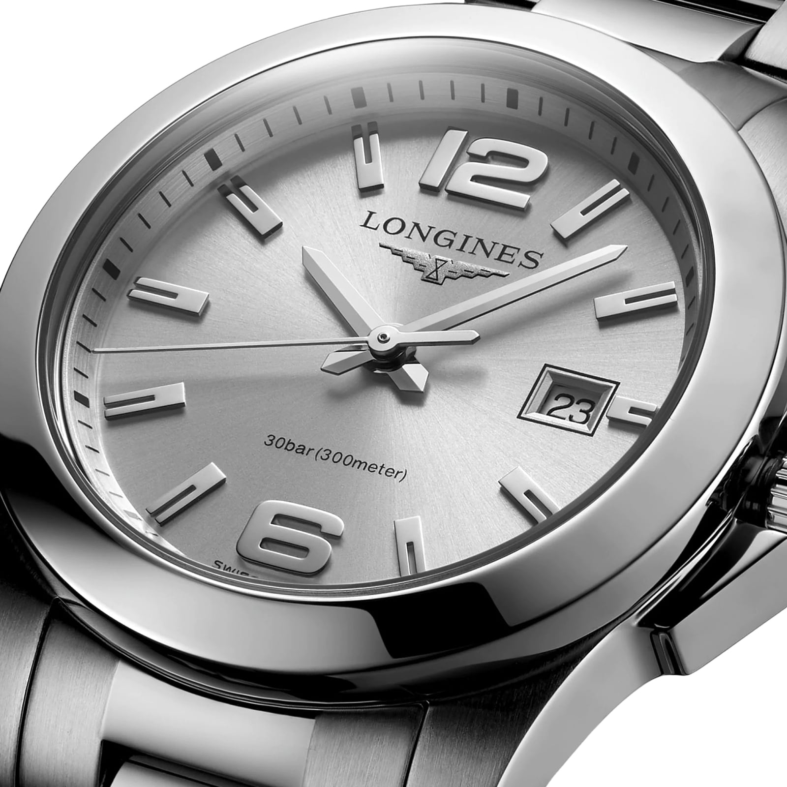 Close-up of a silver Longines Conquest watch with metal bracelet, date window at 23, and silver hour markers—highlighting the performance elegance of the Longines Conquest collection.