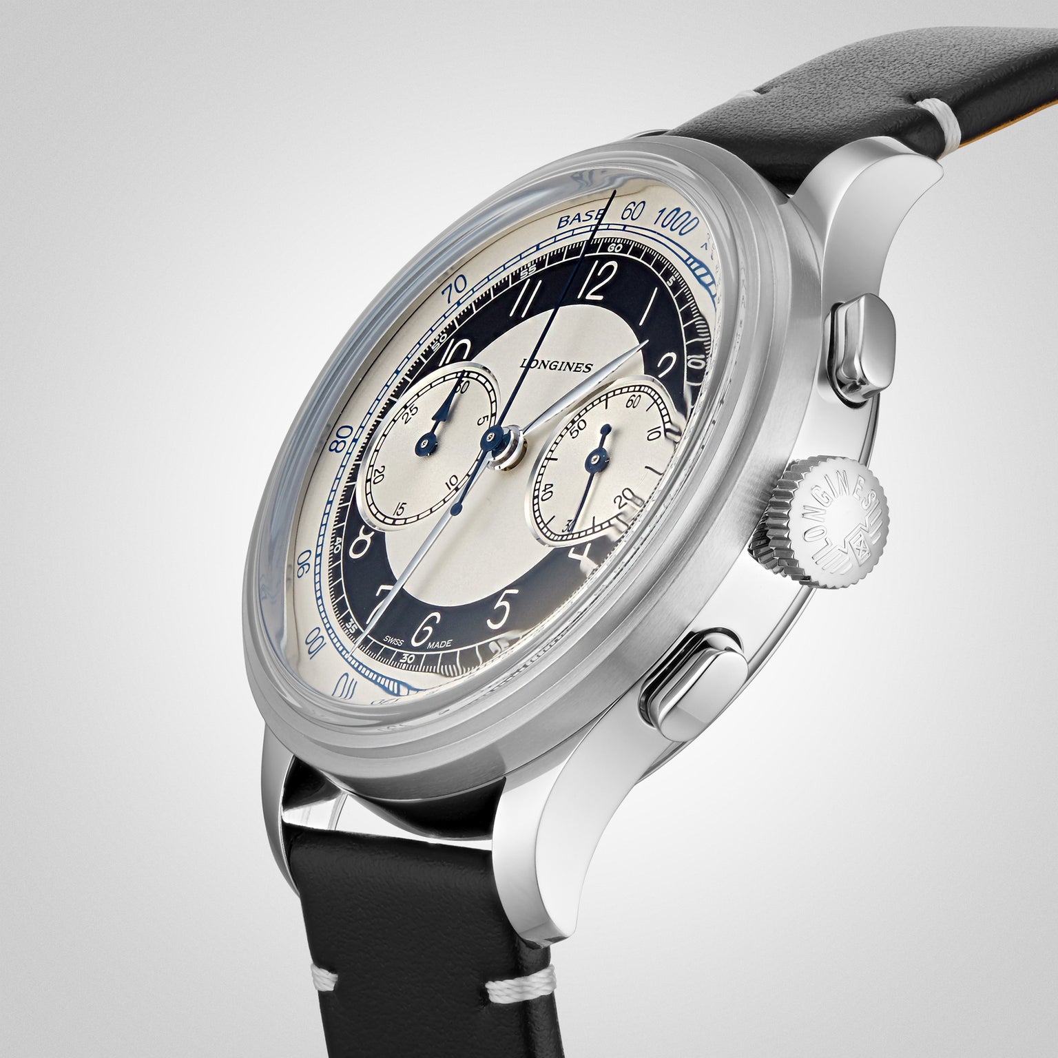 A close-up of the Longines Tuxedo from the Heritage Classic collection, featuring a black and cream dial with two subdials, stainless steel case, and black leather strap, photographed against a plain background.