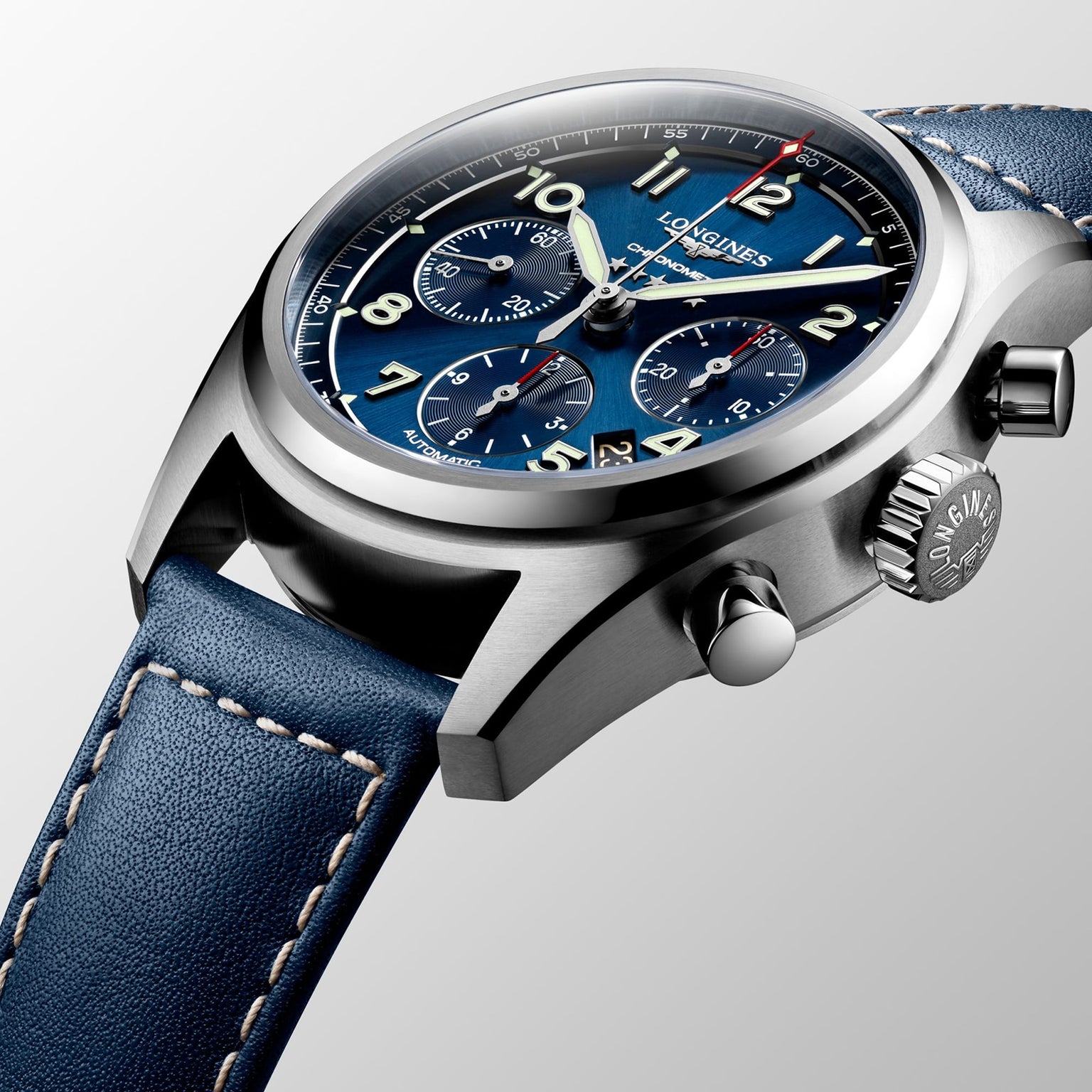 Close-up of the Longines Spirit Chronograph, showcasing its 42mm stainless steel case, blue dial with three subdials, and a blue leather strap accented with white stitching.