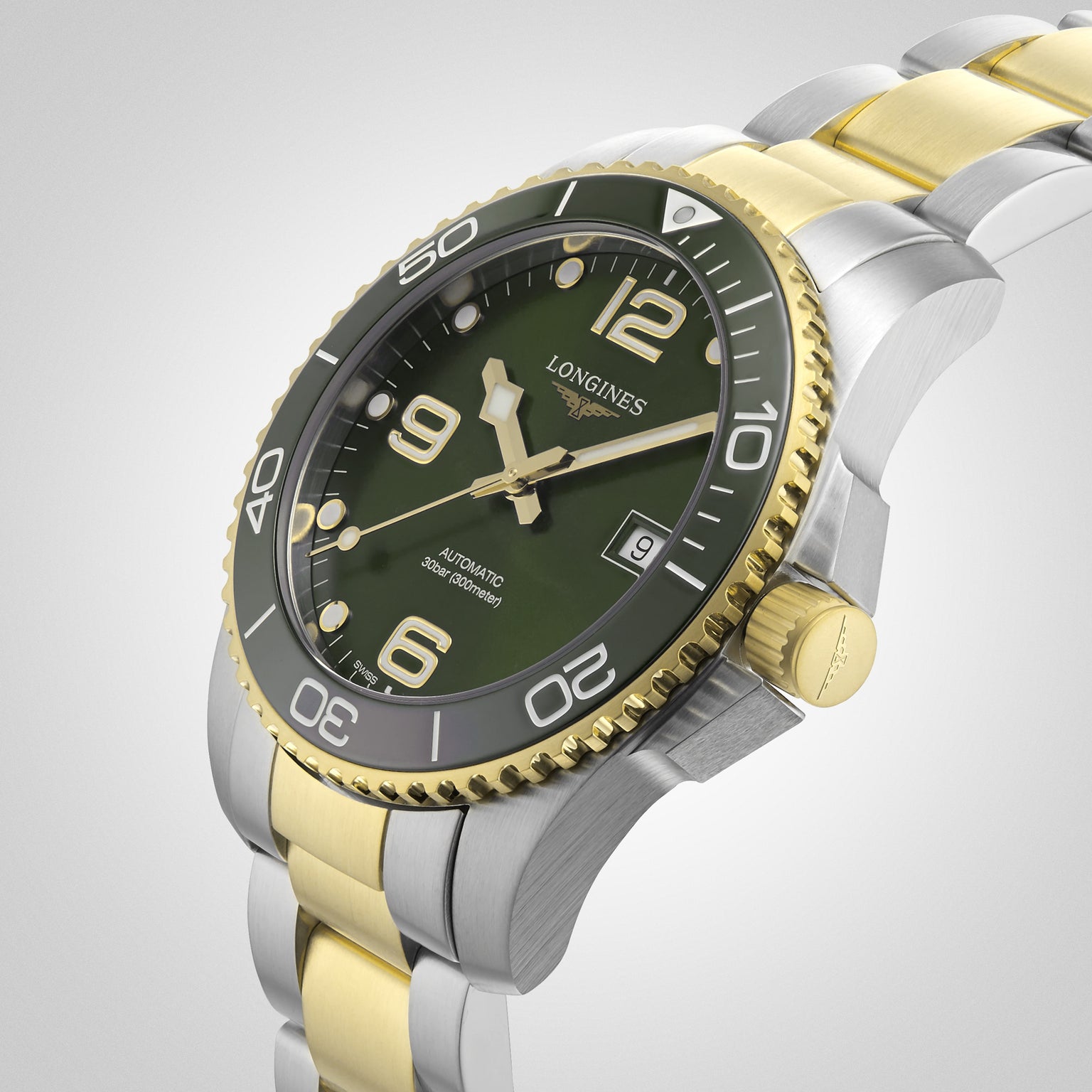 The Longines HydroConquest is an automatic diving watch featuring a green dial, gold bezel accents, a stainless steel and gold bracelet, and a date display at 3 o’clock.