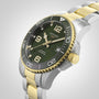 The Longines HydroConquest is an automatic diving watch featuring a green dial, gold bezel accents, a stainless steel and gold bracelet, and a date display at 3 o’clock.