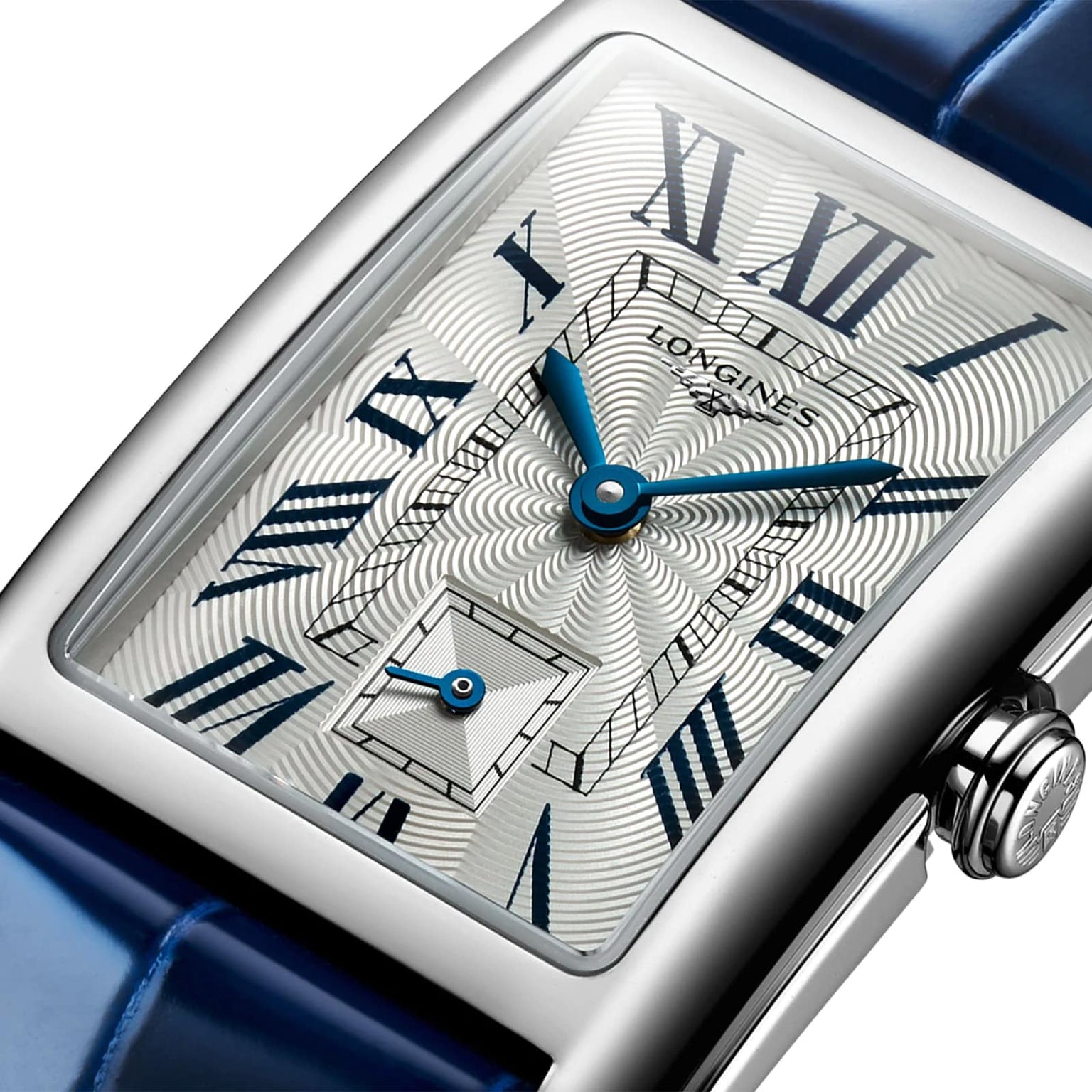 Close-up of a Longines DolceVita watch with a stainless steel case, patterned dial, blue Roman numerals and hands, and a blue leather strap.