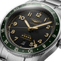 The Longines Spirit Zulu Time is a 42mm stainless steel automatic watch featuring a green bezel, anthracite dial, gold-tone hands and numerals, a date window at 6 o’clock, and ‘Zulu Time’ above the date.