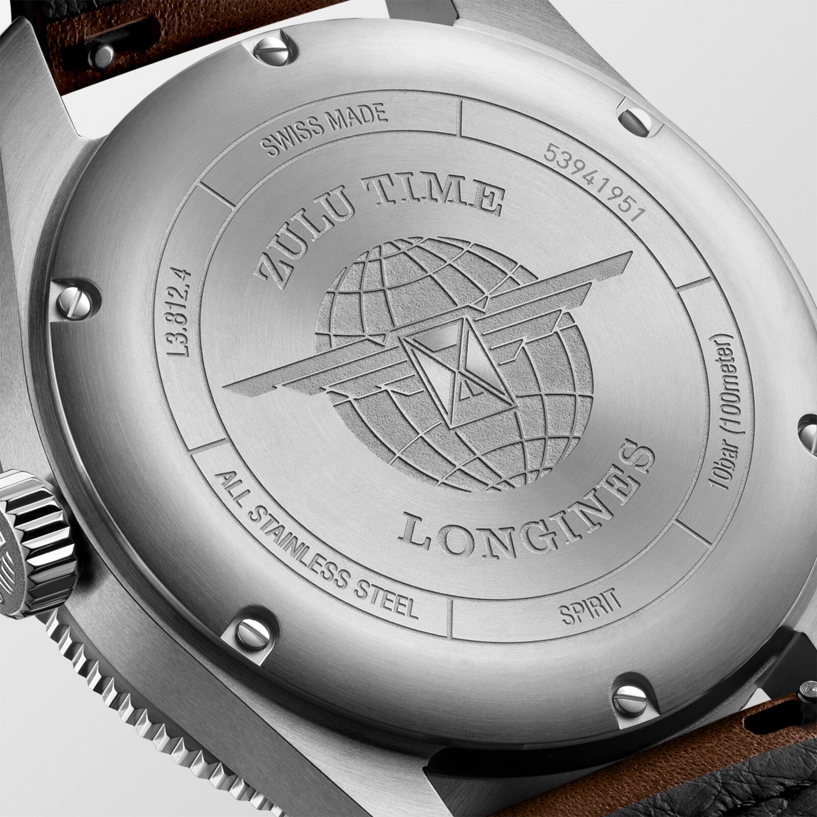 Close-up of the Longines Spirit Zulu Time’s stainless steel case back, featuring “Zulu Time,” a globe motif, multiple time zone markings, serial numbers, and “All Stainless Steel.”.