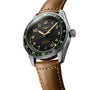 The Longines Spirit Zulu Time watch features a stainless steel case, black dial with gold numerals, green bezel, brown leather strap, and offers multiple time zones and date display.