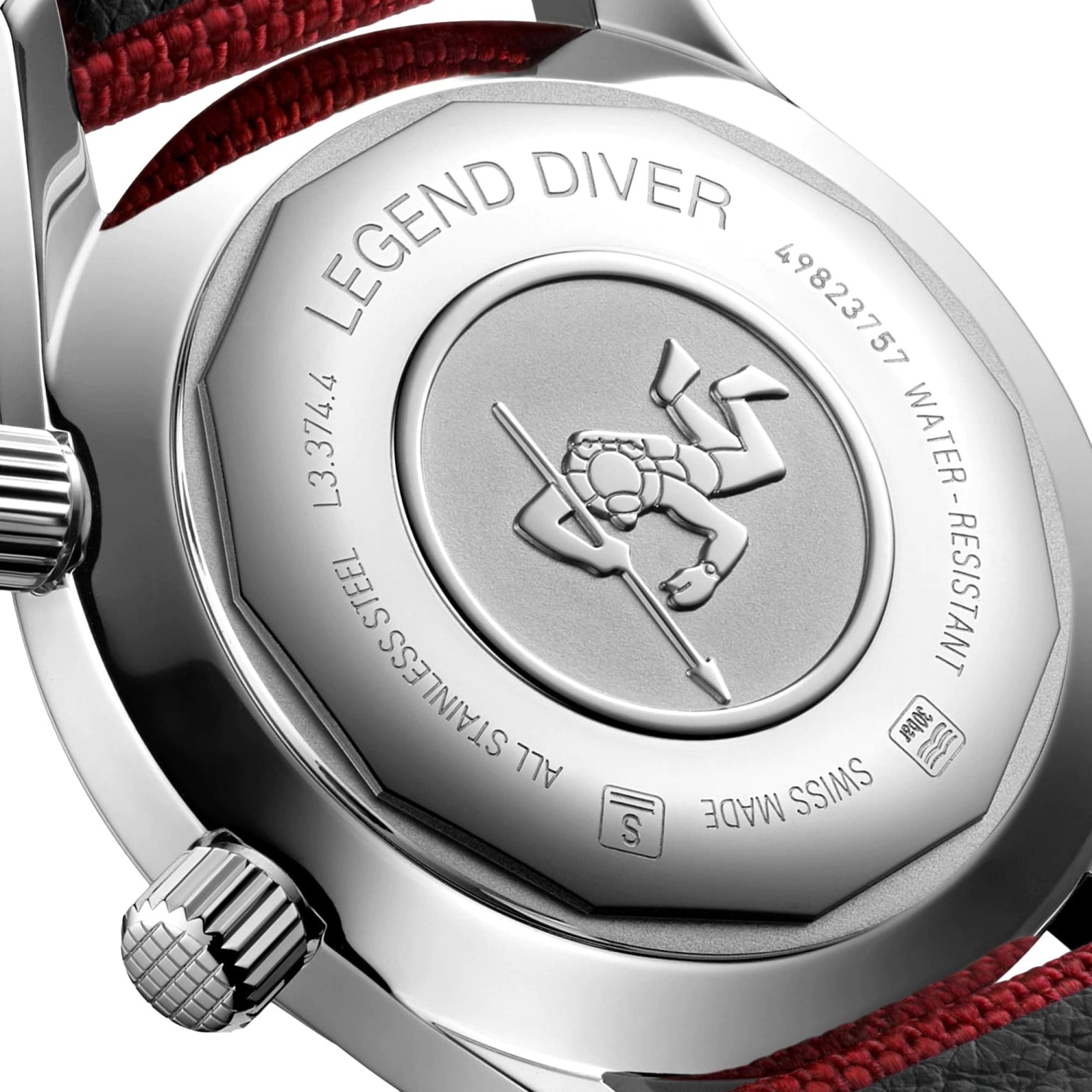 Close-up of the Longines Legend Diver’s case back displays engraved text and a diving figure emblem, featuring a stainless steel finish and a red-black strap detail.