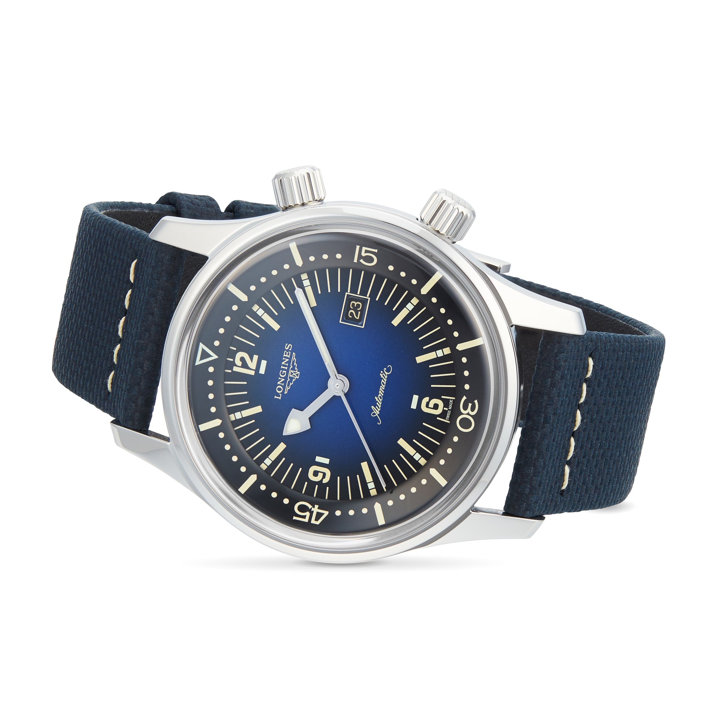 A Longines Legend Diver watch with a blue dial, black strap, silver bezel, luminous hands and markers, two crowns, and automatic movement is shown at an angle on a white background.
