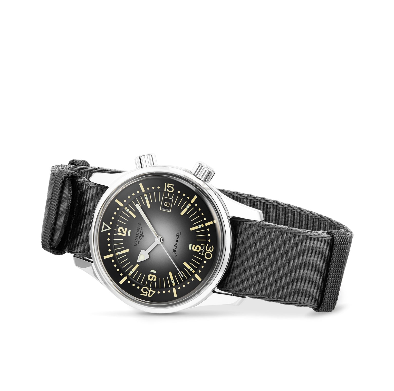 The Longines Legend Diver, featuring a black dial with yellow luminous markers, two pushers, and a black fabric strap, is displayed against a white background.