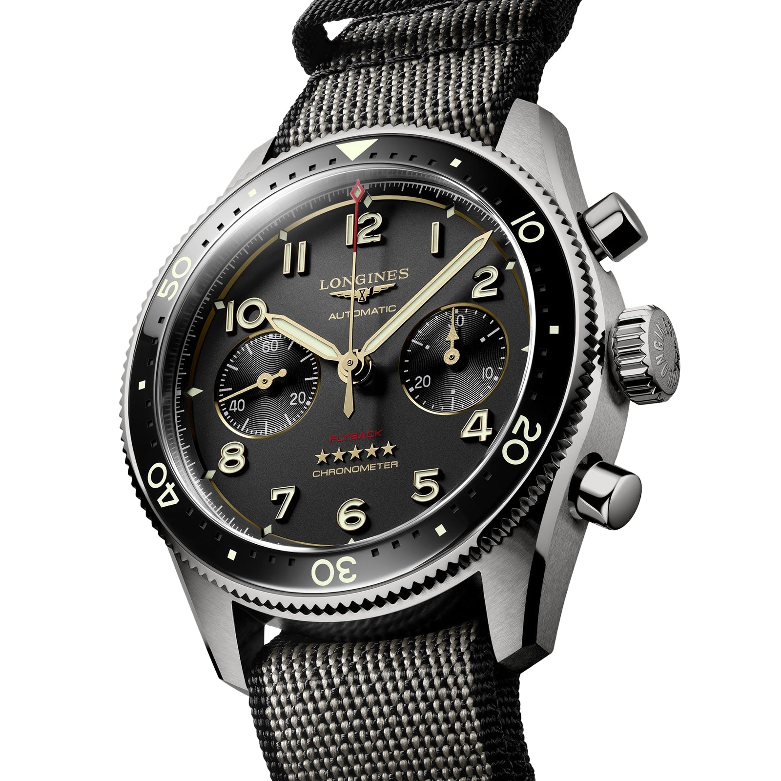 Close-up of the Longines Spirit Flyback Titanium, an automatic chronograph pilot watch featuring a black dial, luminous numbers, two subdials, titanium case, and a textured fabric strap.
