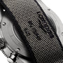 Close-up of the Longines Spirit Flyback Titaniums back, highlighting its titanium case, partly covered by a textured fabric strap with visible stitching and embossed text.