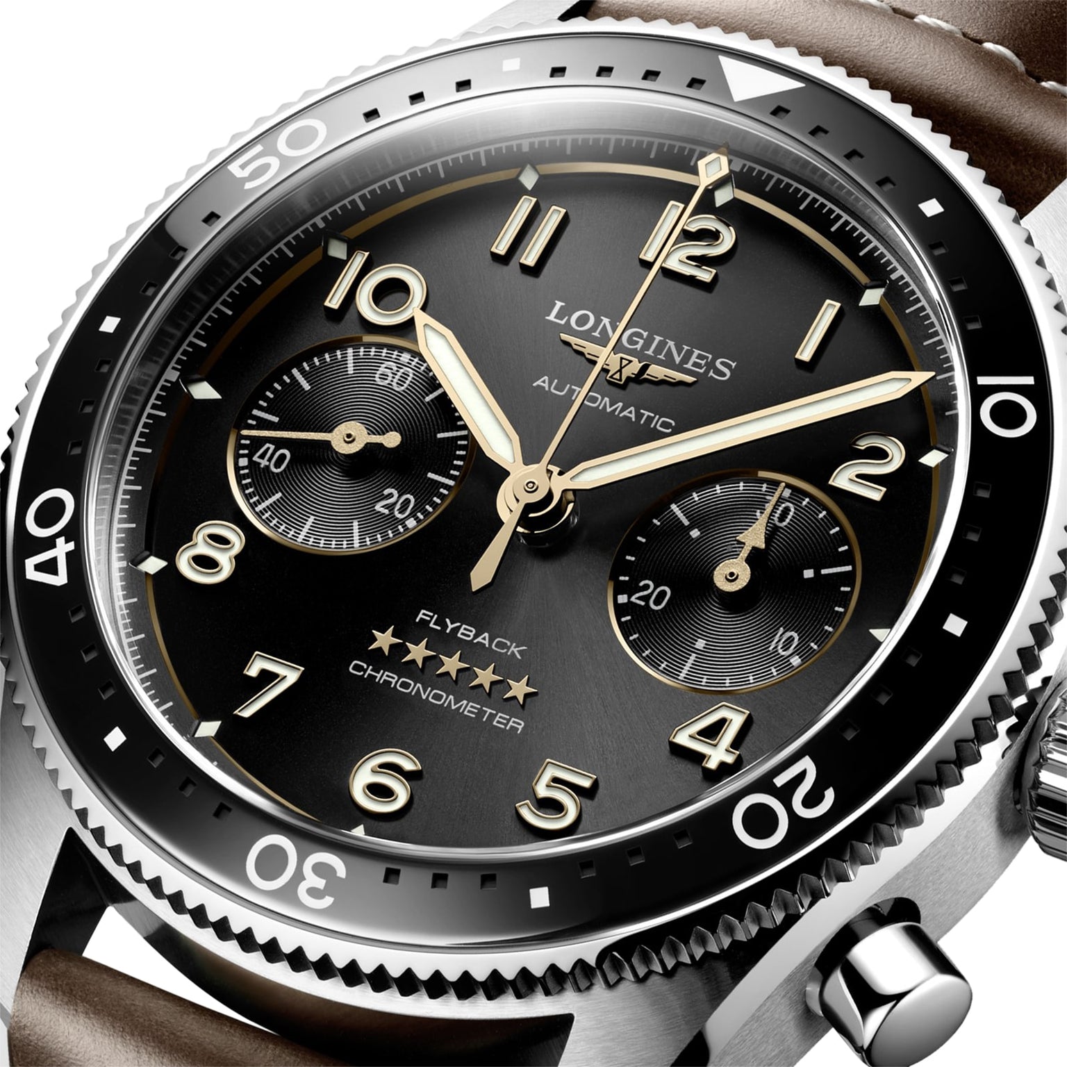Close-up of the Longines Spirit Flyback, an automatic chronometer wristwatch with COSC certification, flyback function, black dial, gold numerals and hands, two subdials, and a stainless steel case.