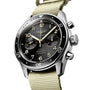 A close-up of the Longines Spirit Flyback automatic chronograph, featuring a black dial, beige numerals, light khaki fabric strap, and powered by the precise automatic calibre L791.